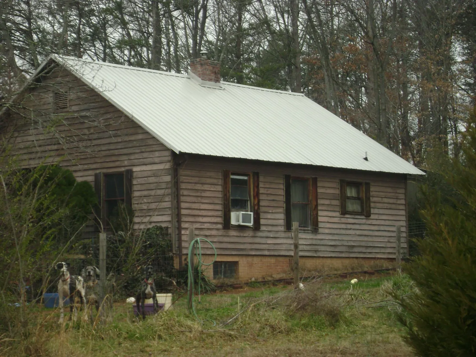 White metal roof on an old wood sided farmhouse, from a Metal Roof Installation job in Waverly